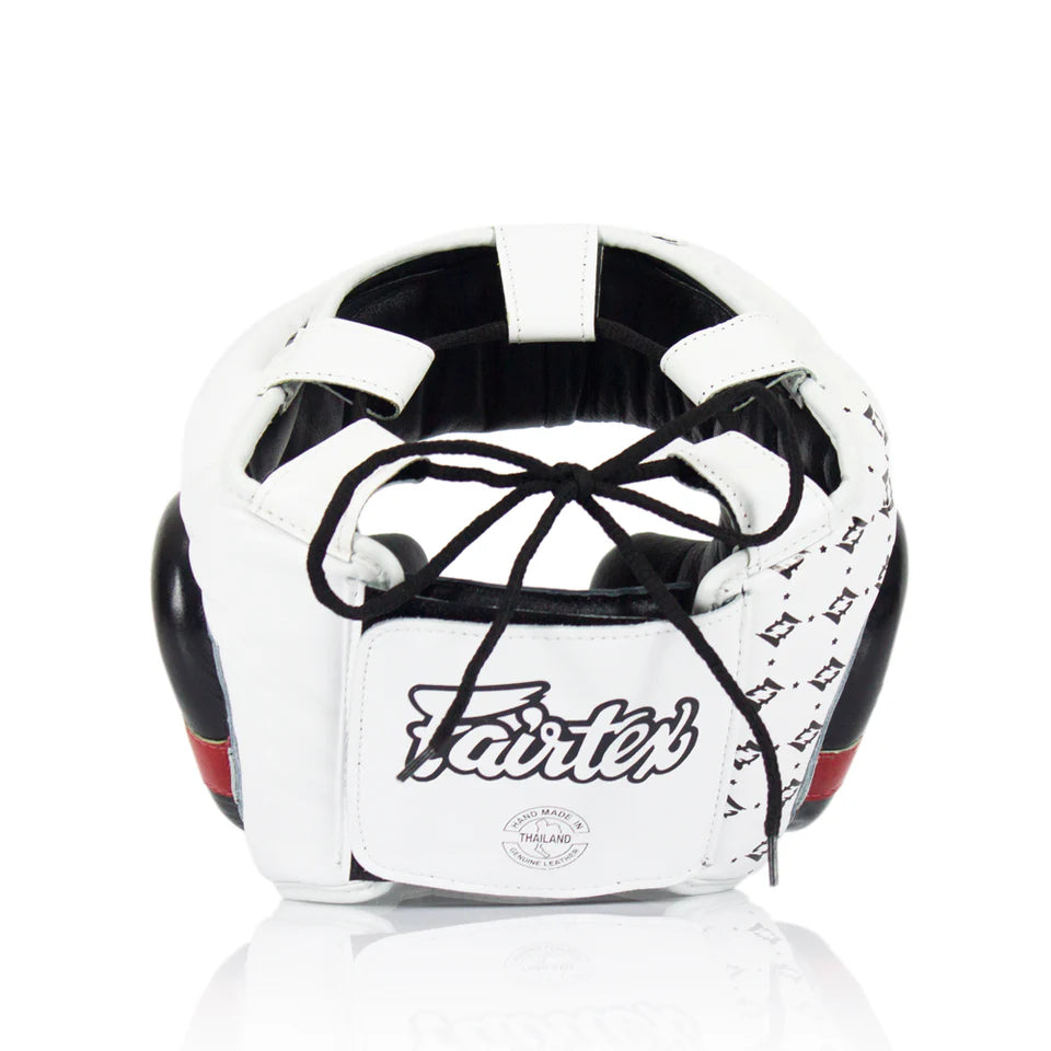 Rear profile of a black and white boxing headgear with Fairtex logo on a white background