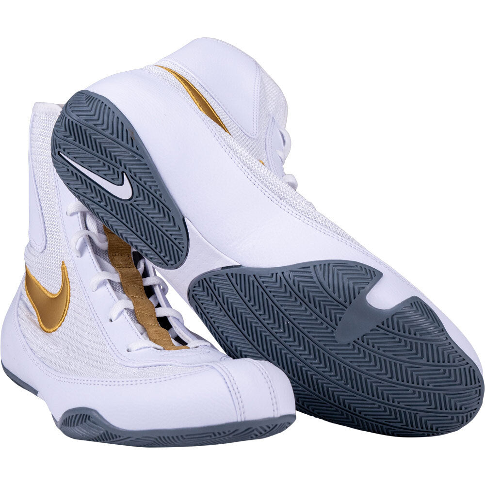 White high-top boxing sneakers with gold accents and Nike logo on a white background