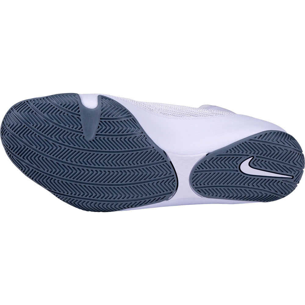 Close-up of a white Nike boxing shoe with a blue sole on a white background