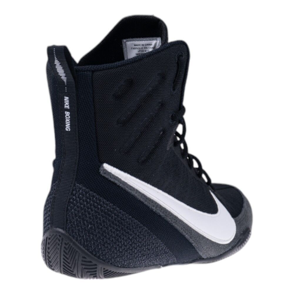 Black boxing shoe with white Nike logo on a white background