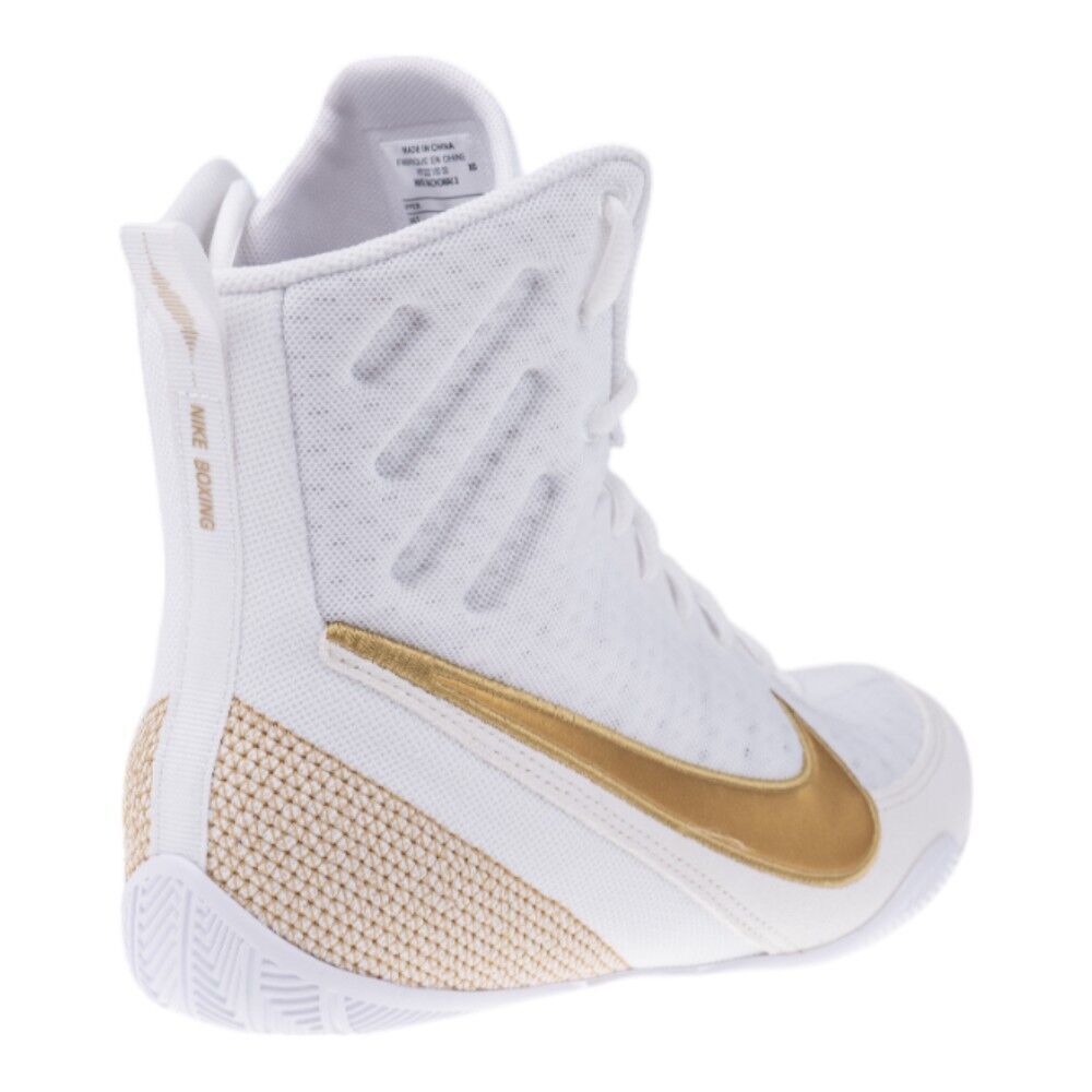 White and gold sneaker with Nike logo on a white background