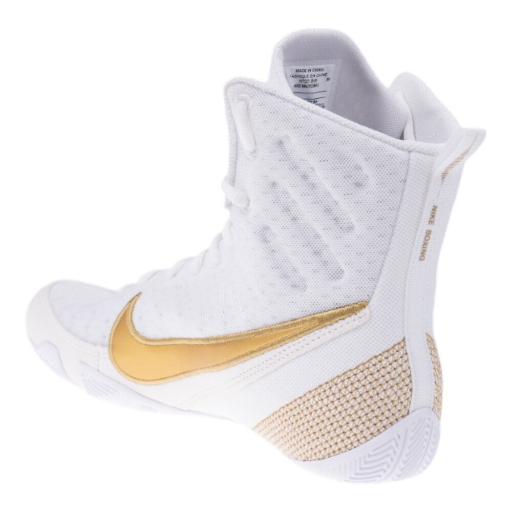 White and gold Nike high-top sneaker on a white background