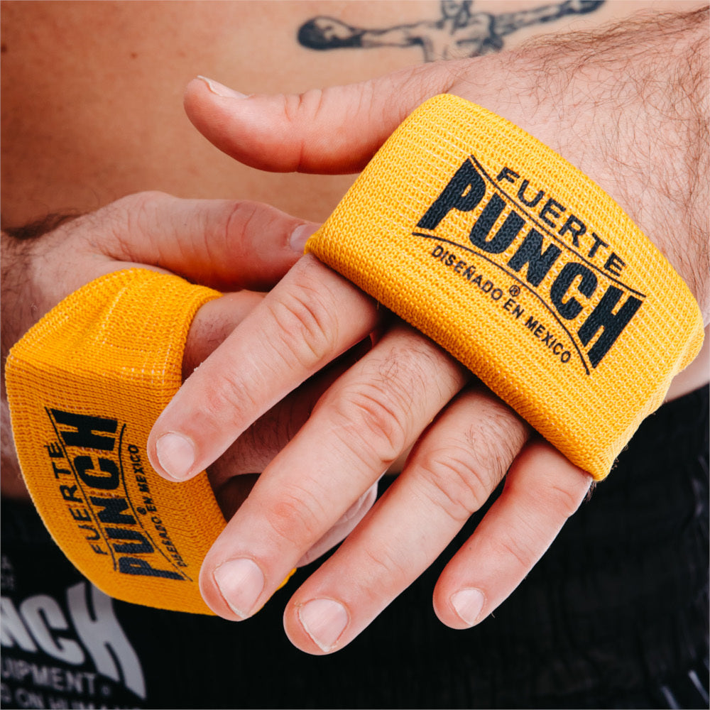 Yellow boxing knuckle guards with 'Punch' branding on a person's wrist.