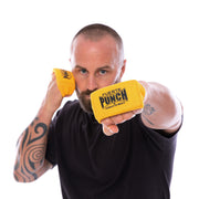 Man wearing yellow boxing knuckle guards with 'Fuerte Punch' branding on a white background