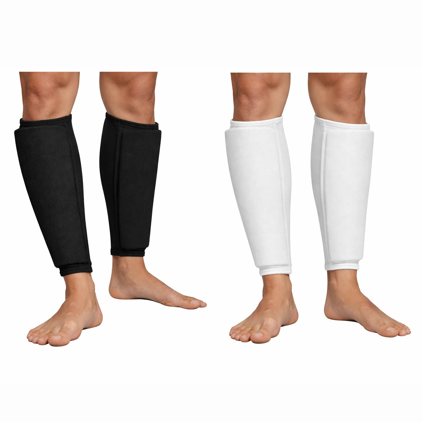 Black and white shin pads on a person's legs against a white background