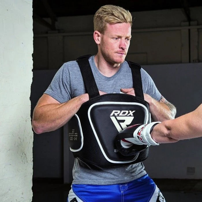 Person wearing an RDX boxing belly pad on a training session