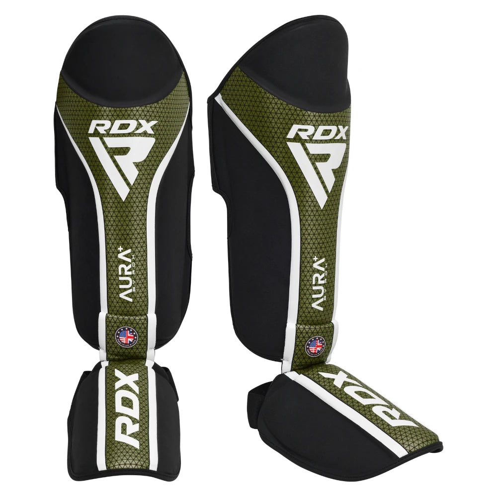 Pair of RDX shin guards with green and black design on a white background