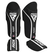Black RDX shin guards with white accents on a white background