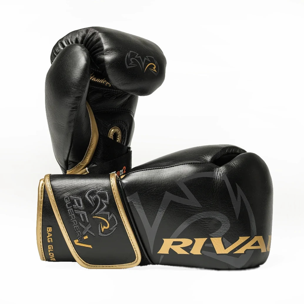 Black boxing gloves with gold accents and 'Rival' branding on a white background