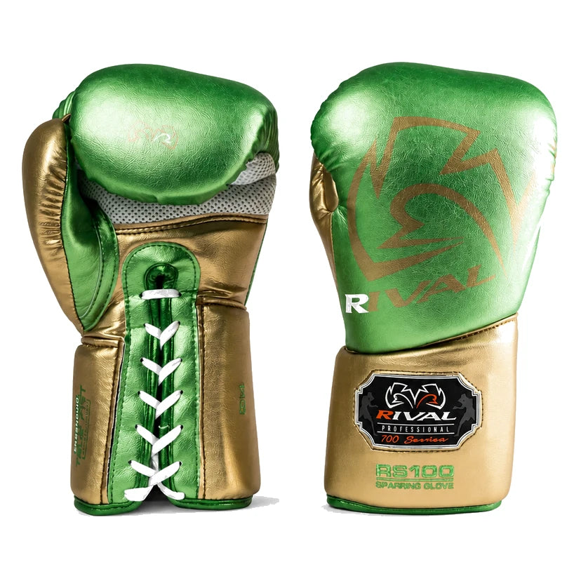 A pair of metallic green and gold Rival boxing gloves shown from the front and back on a clean white background. The gloves feature a metallic green and gold color scheme with white laces on one glove and a black and gold Rival brand patch on the wrist strap.