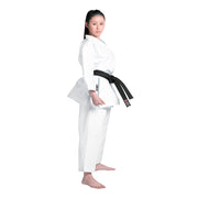 Woman wearing a white martial arts uniform with a black belt on a white background