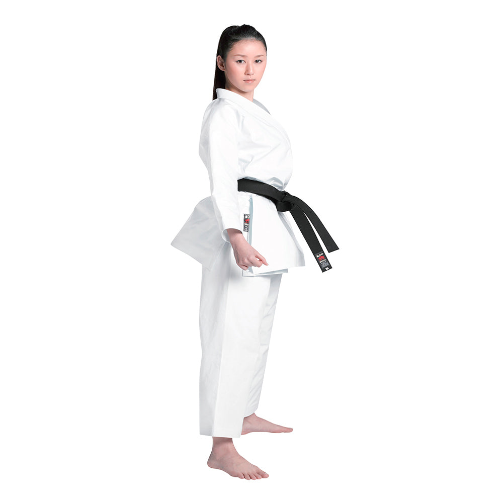 Woman wearing a white martial arts uniform with a black belt on a white background