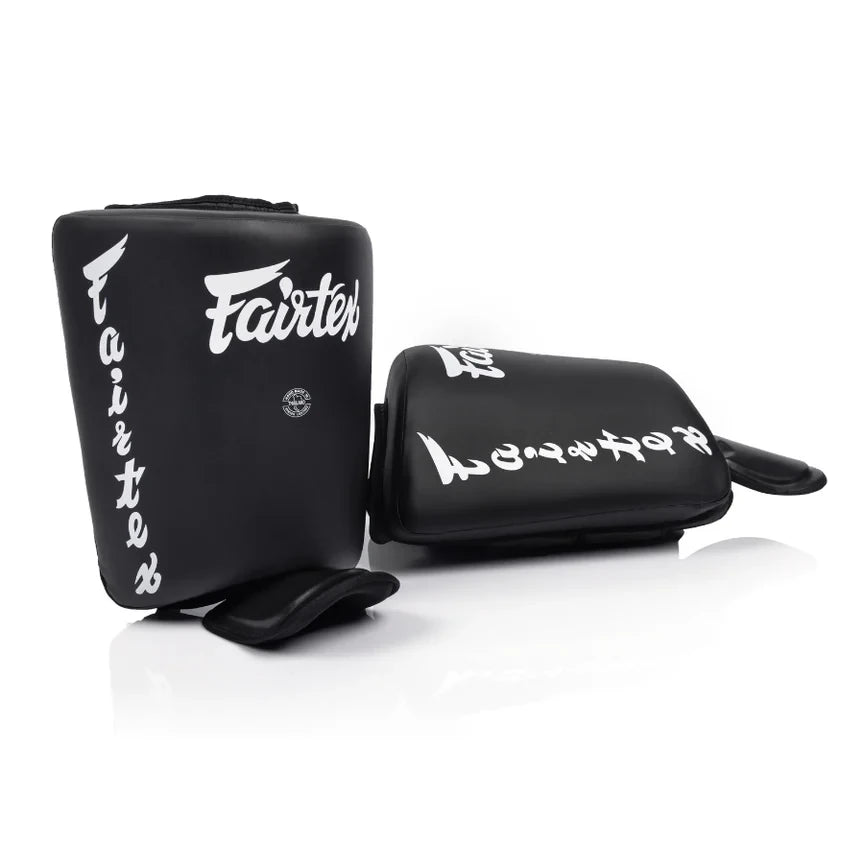 Black shin and calf pads with 'Fairtex' branding on a white background
