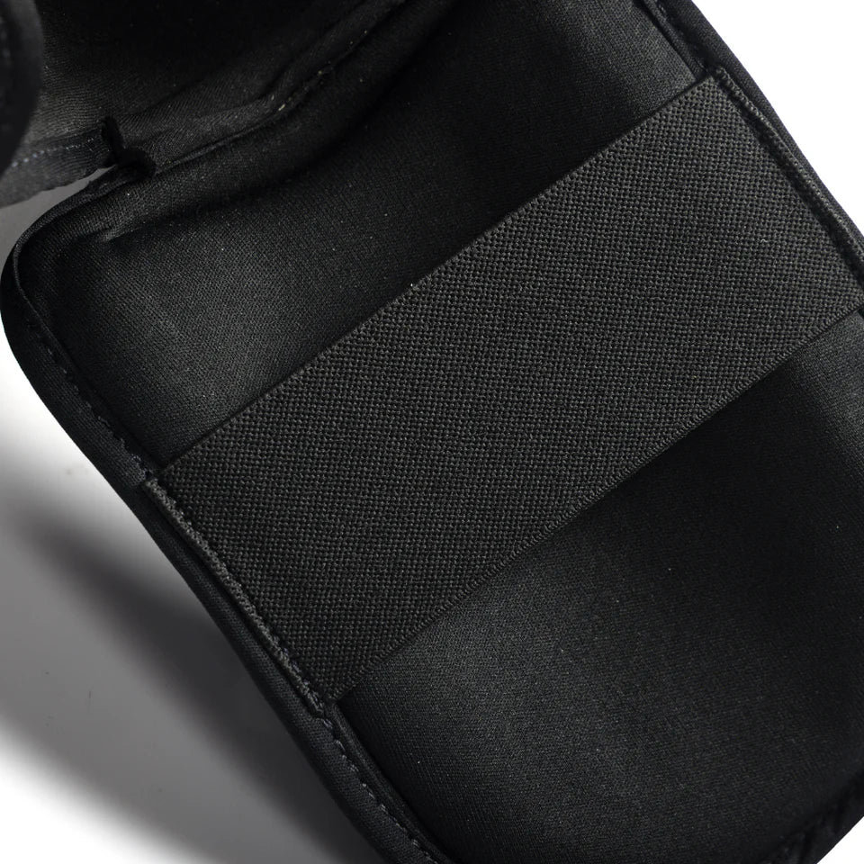 Close-up of the bottom view of the foot guard on the Fairtex shin guard on a white background