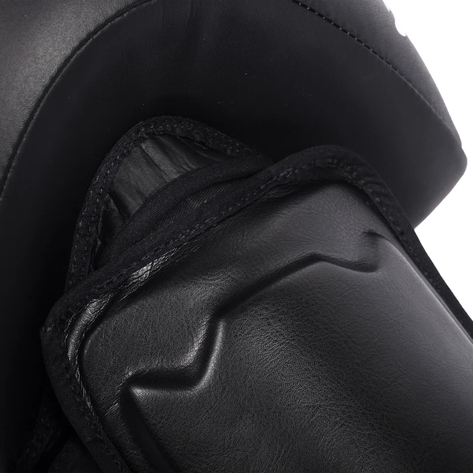 Close-up of a black shin guard with a white background