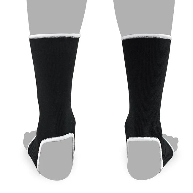 Black anklets with white soles on a gray background