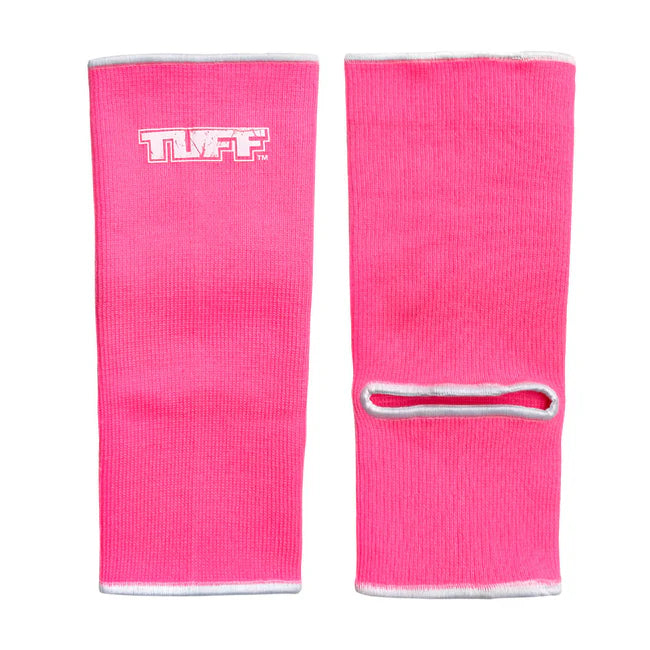 Pair of pink ankle guards with a white logo on a white background