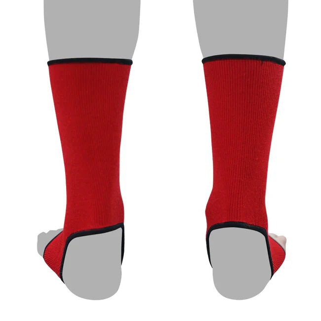 Red anklets with black accents worn by a person on a white background