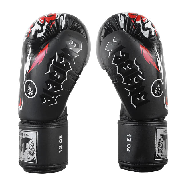 Pair of black boxing gloves with red and white designs on a white background
