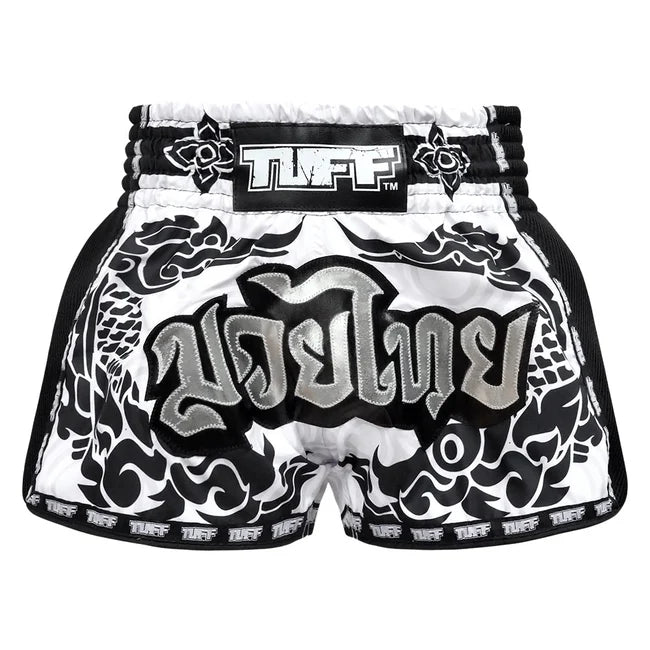 Black and white Muay Thai shorts with 'TUFF' branding on a white background