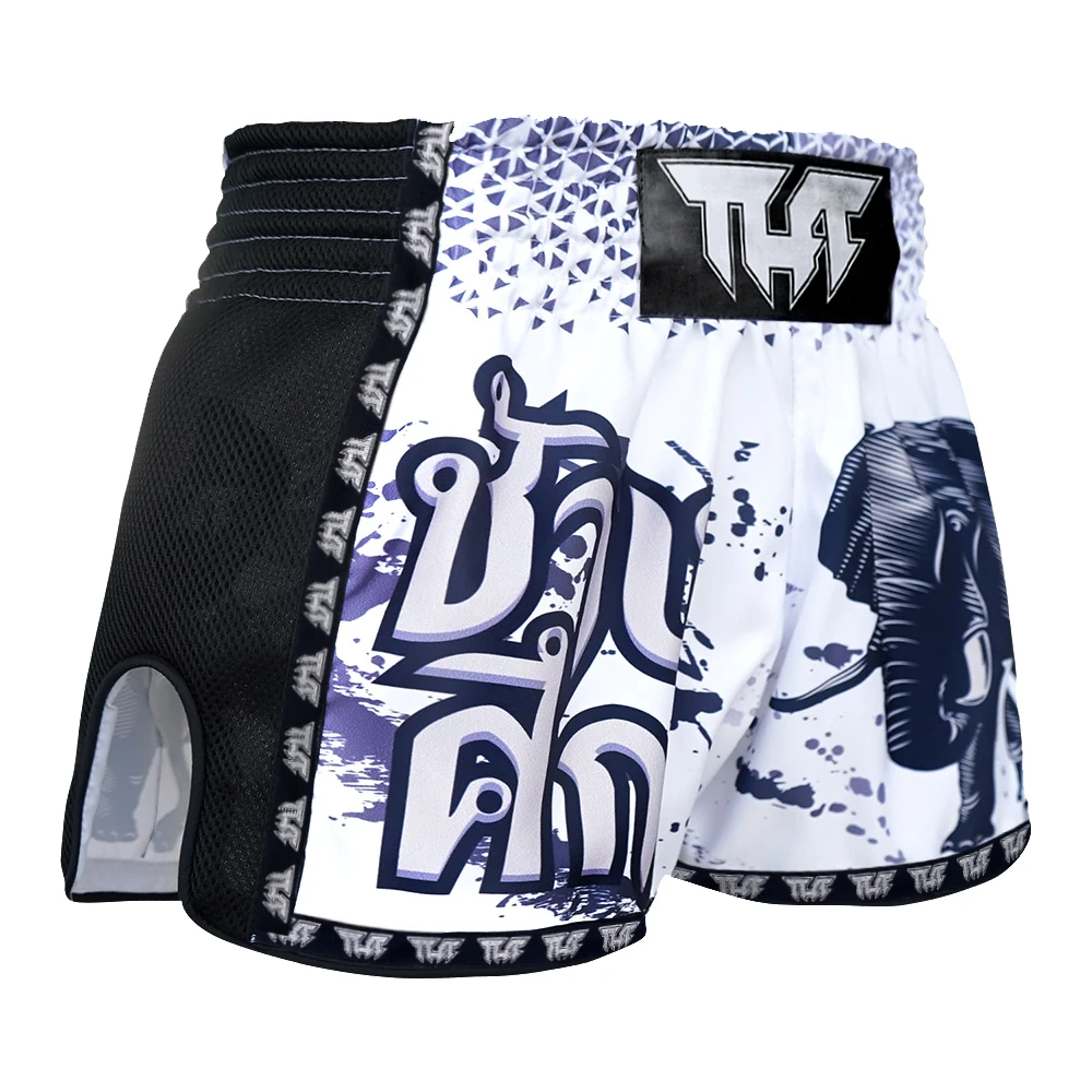 Pair of Muay Thai shorts with a black and white design featuring an elephant and abstract patterns on a white background.