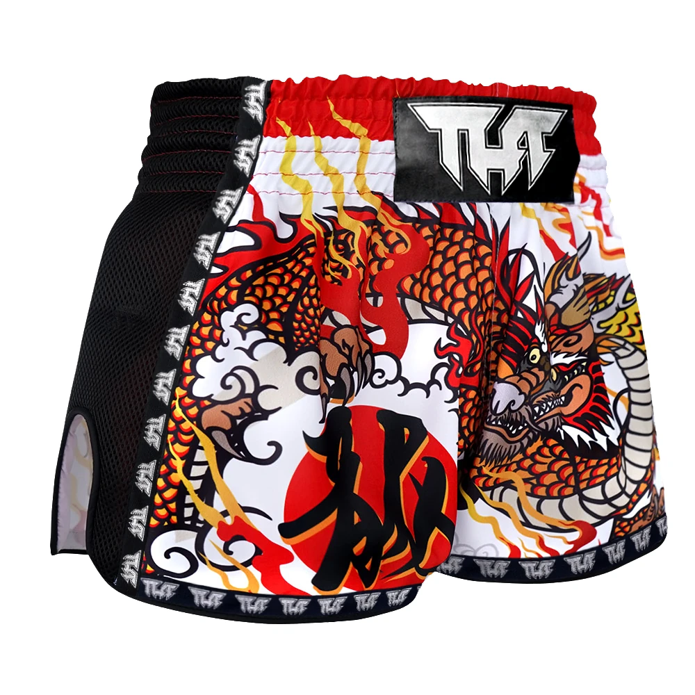 Colorful dragon-themed Muay Thai shorts with a brand logo on a white background