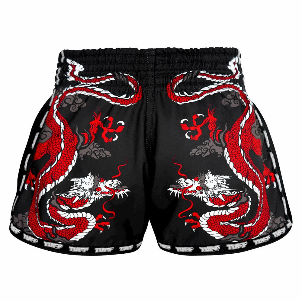 Black Muay Thai shorts with red dragon designs on a white background