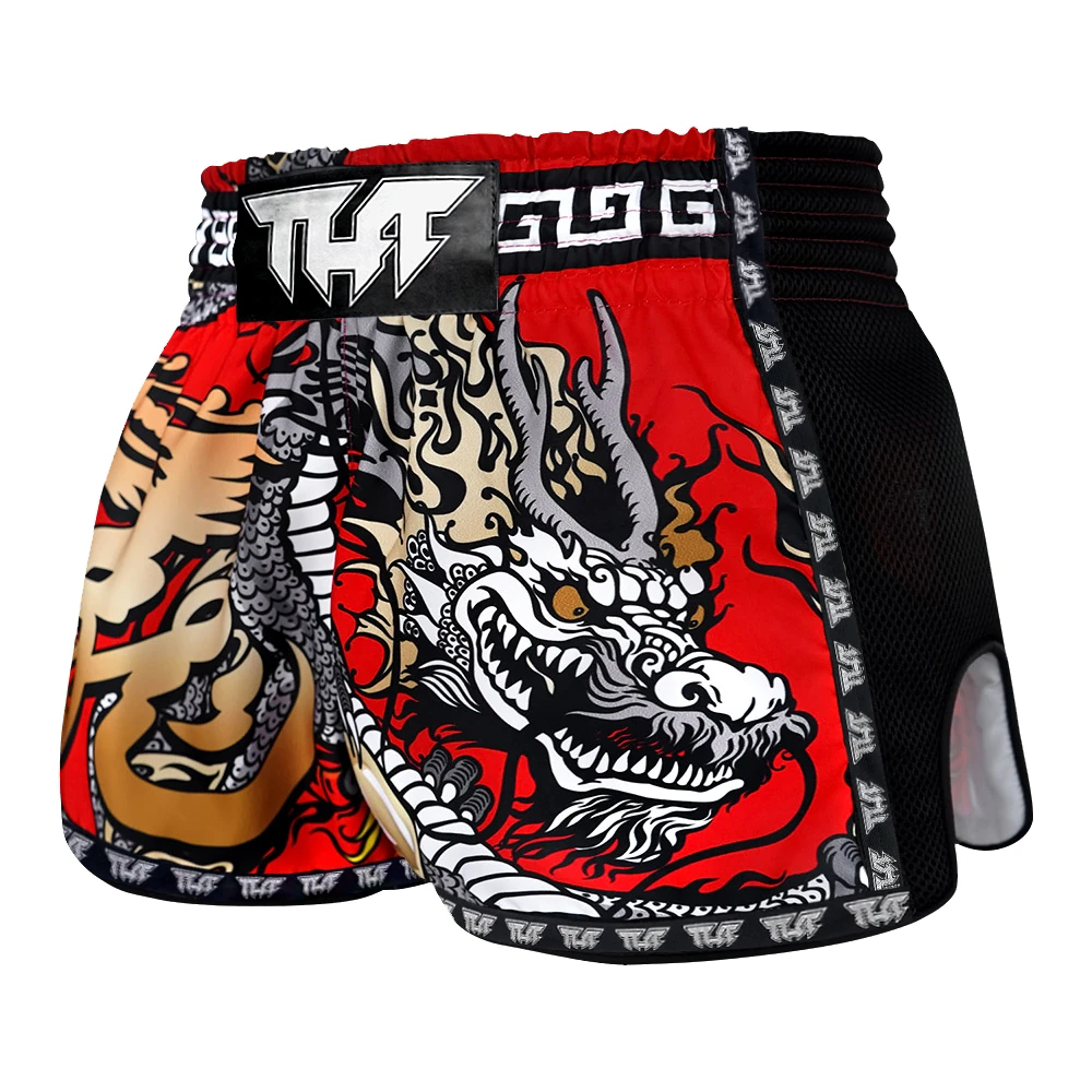 Traditional dragon design on red Muay Thai shorts with a black belt.