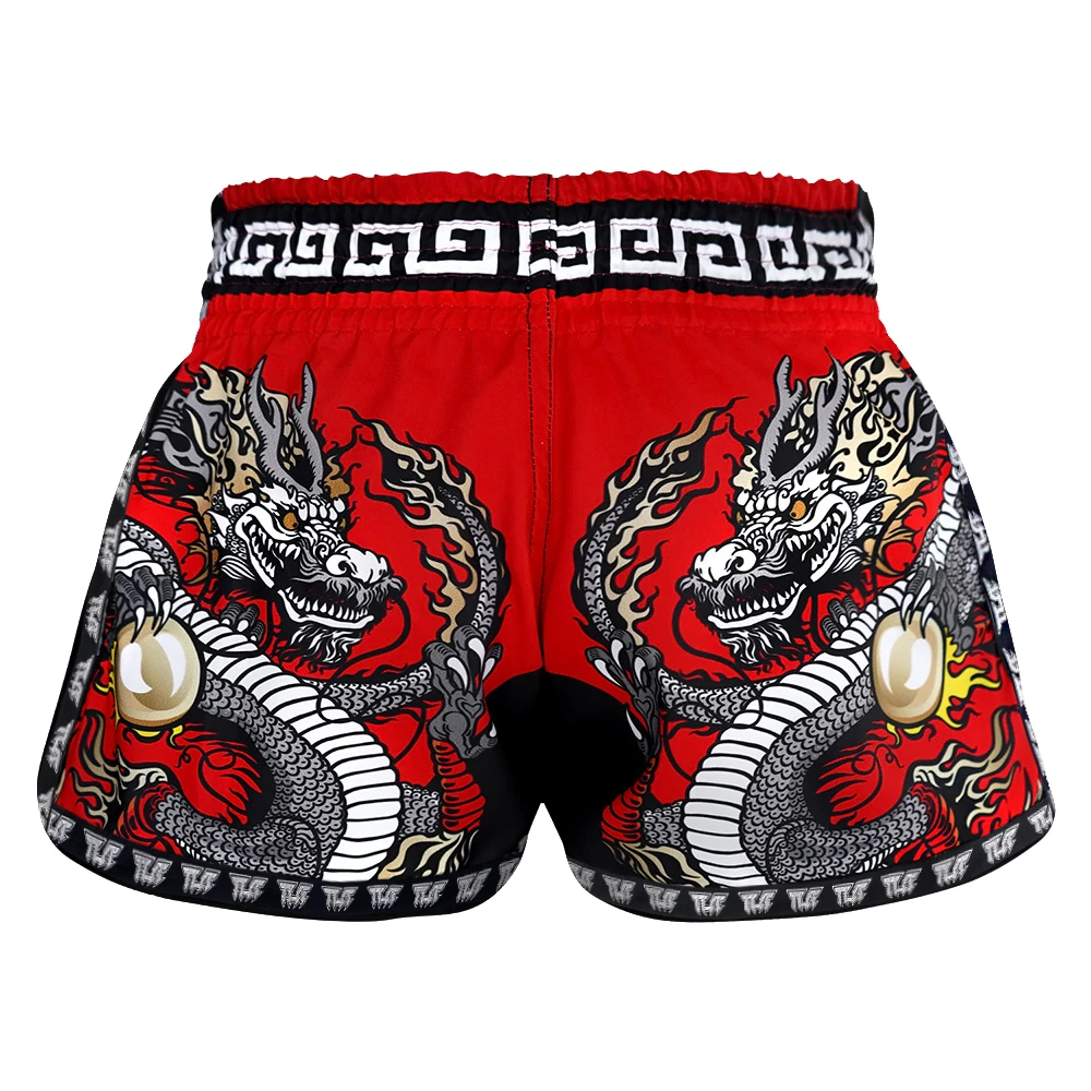 Red Muay Thai shorts with dragon design on a white background