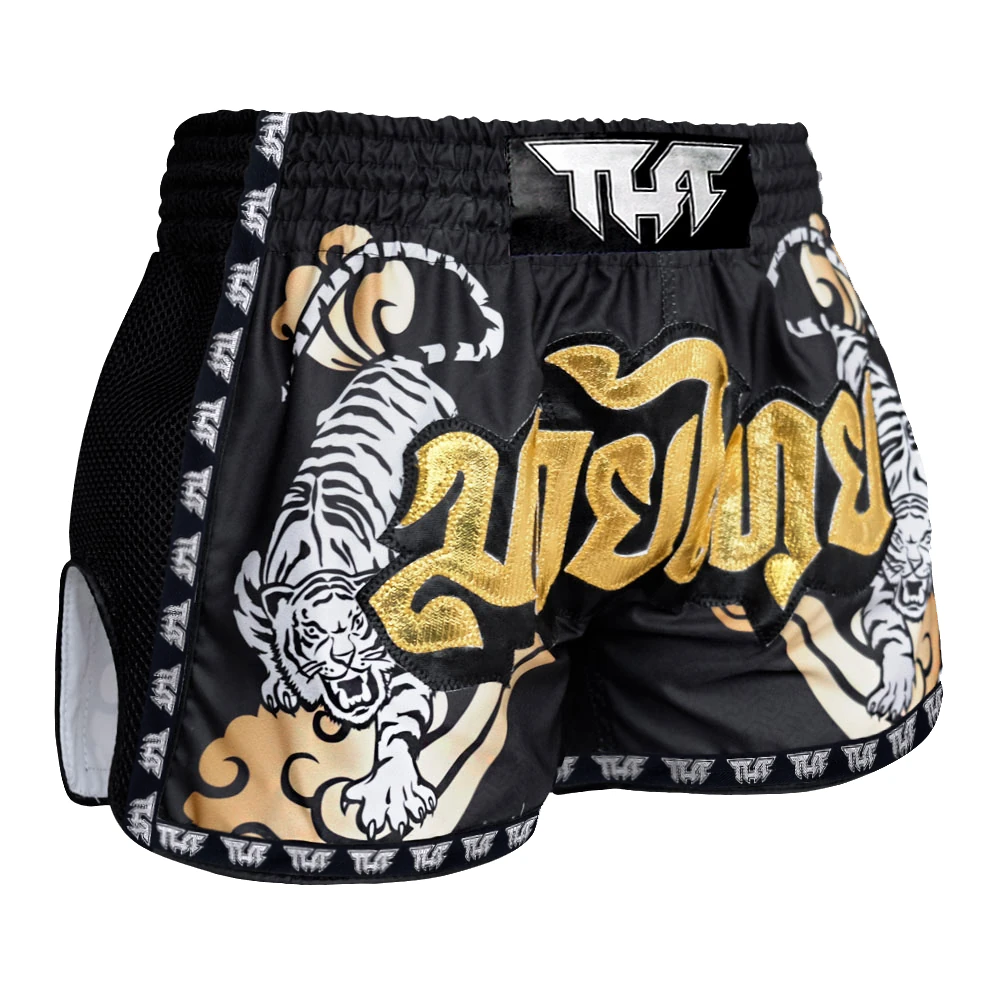 Black Muay Thai shorts with gold and white tiger design and 'TUFF' branding on a white background