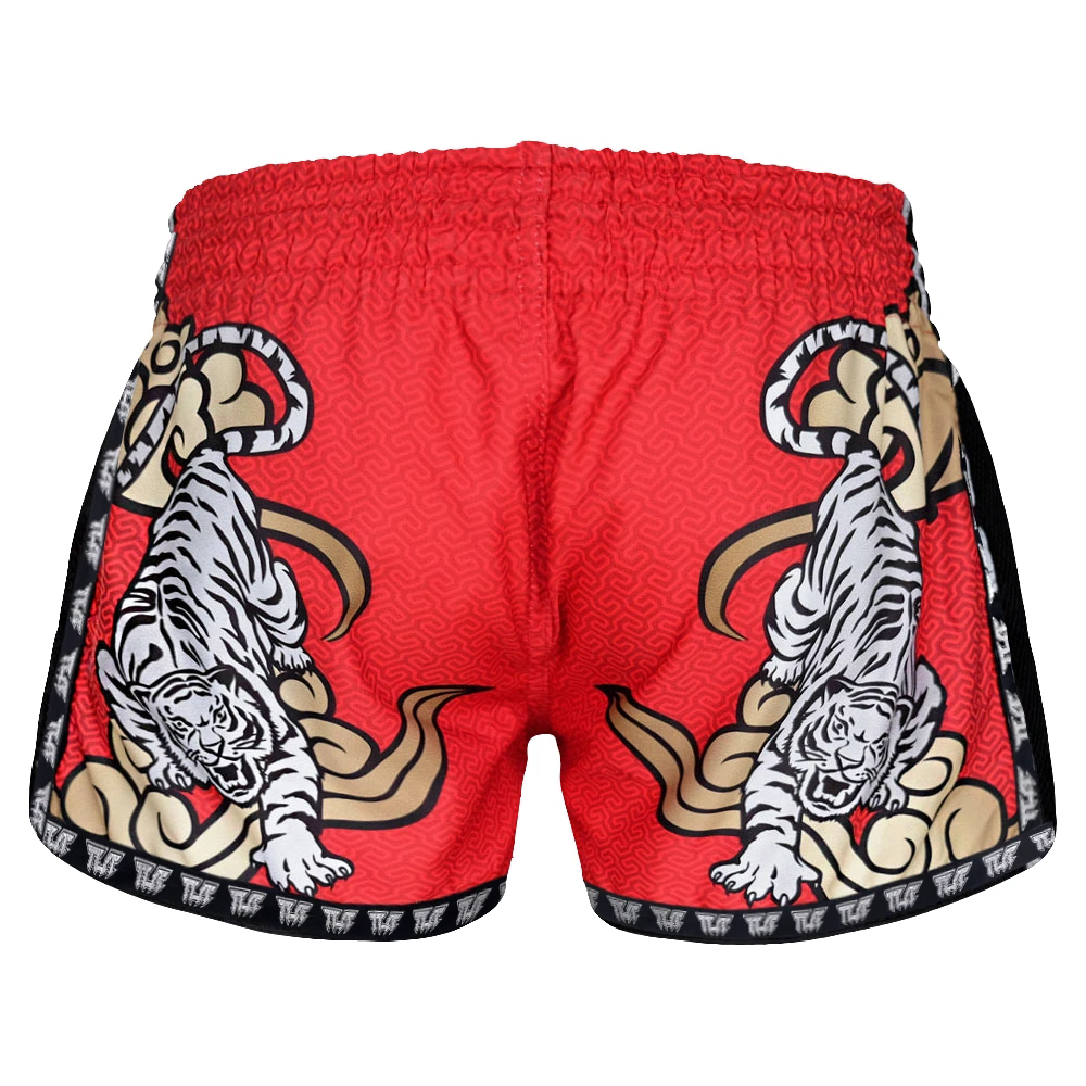 Red Muay Thai shorts with tiger designs on a white background