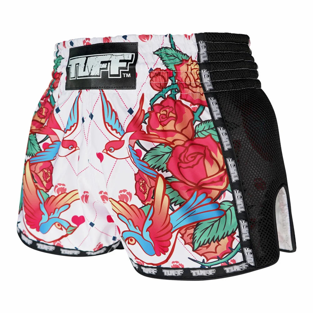 Colorful floral and bird patterned Muay Thai shorts with 'TUFF' branding on a white background