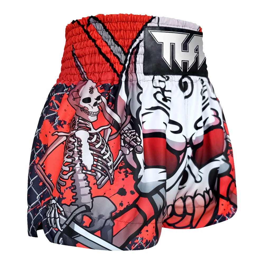 Muay Thai shorts with skeleton design and red accents on a white background