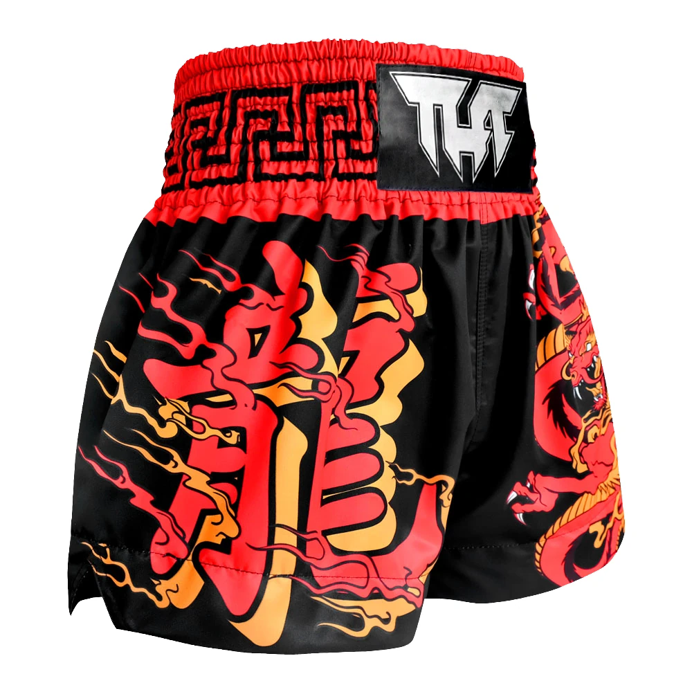 Black Muay Thai shorts with red and yellow dragon design on a white background