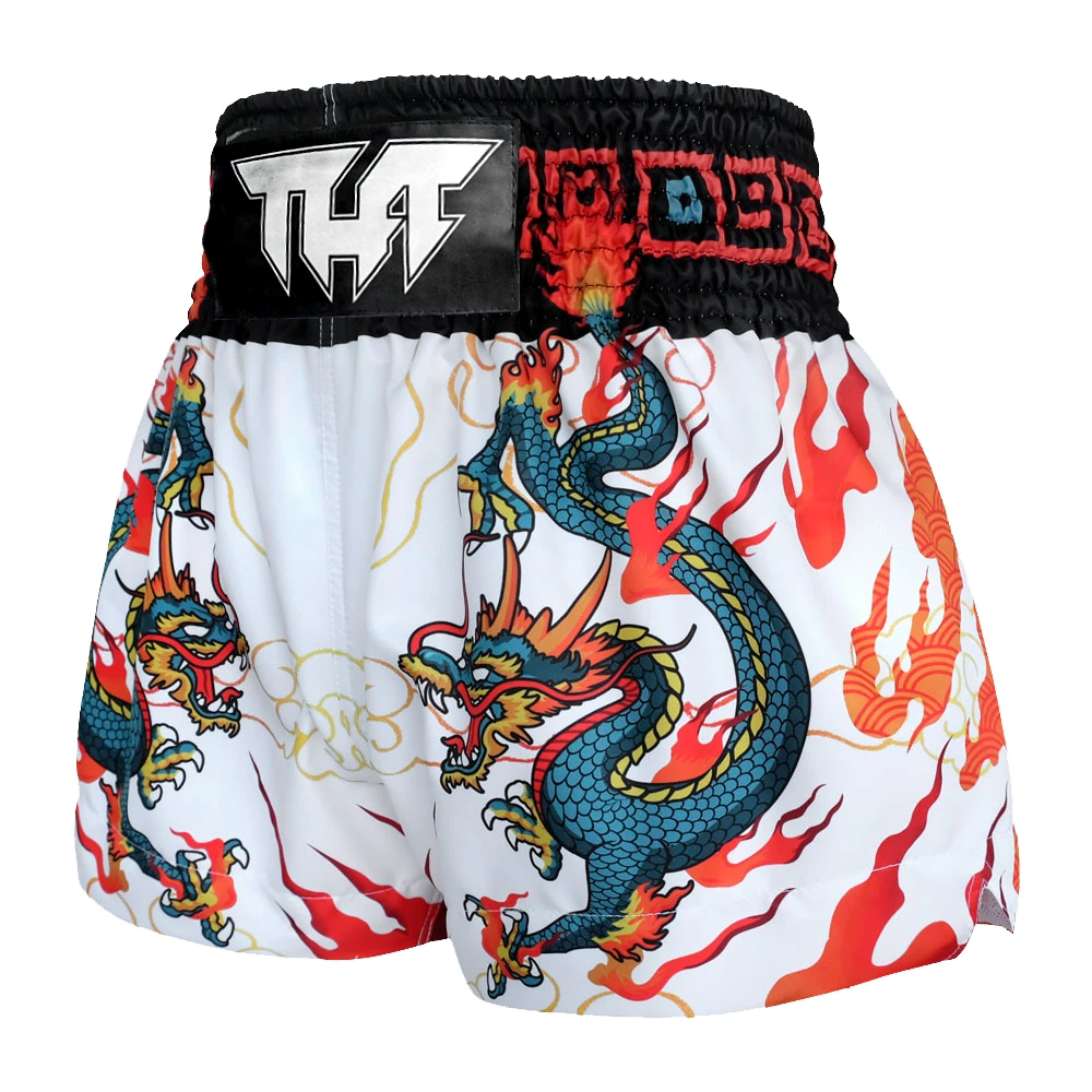 Muay Thai shorts with dragon design and visible brand logo on a white background