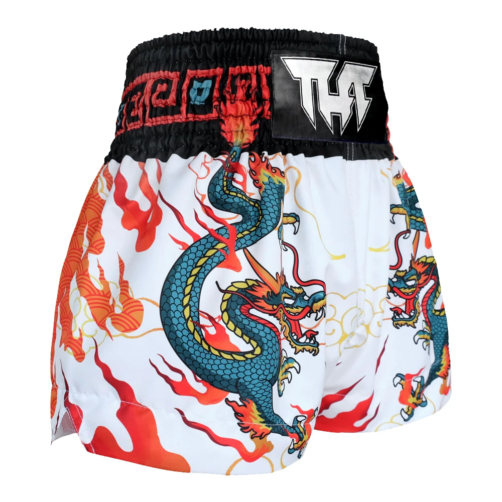 Muay Thai shorts with dragon design and black waistband on a white background