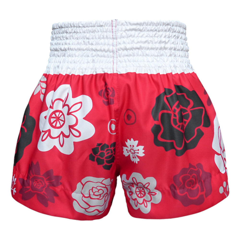 Red Muay Thai shorts with floral patterns on a white background