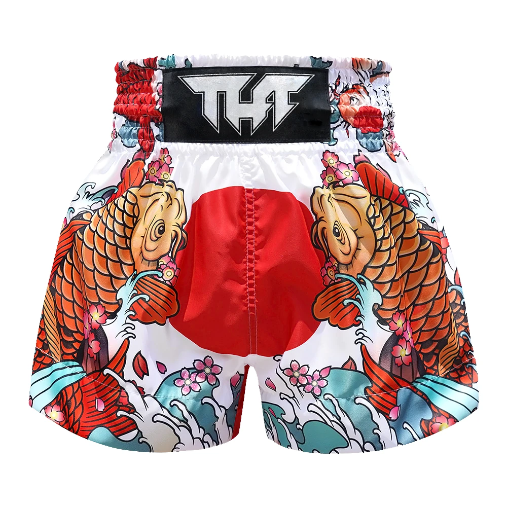 Colorful Muay Thai shorts with koi fish design and visible brand logo on a white background