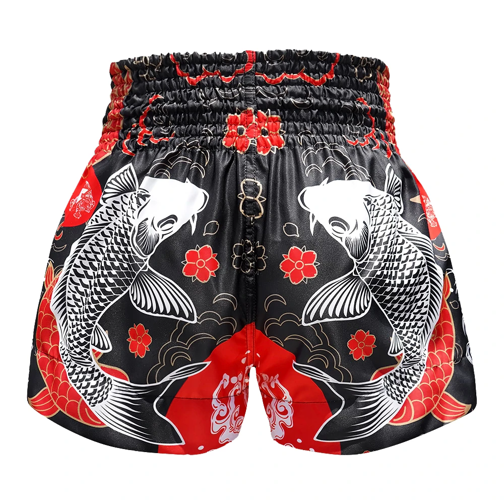 Traditional Muay Thai shorts with Koi fish and floral patterns on a black background