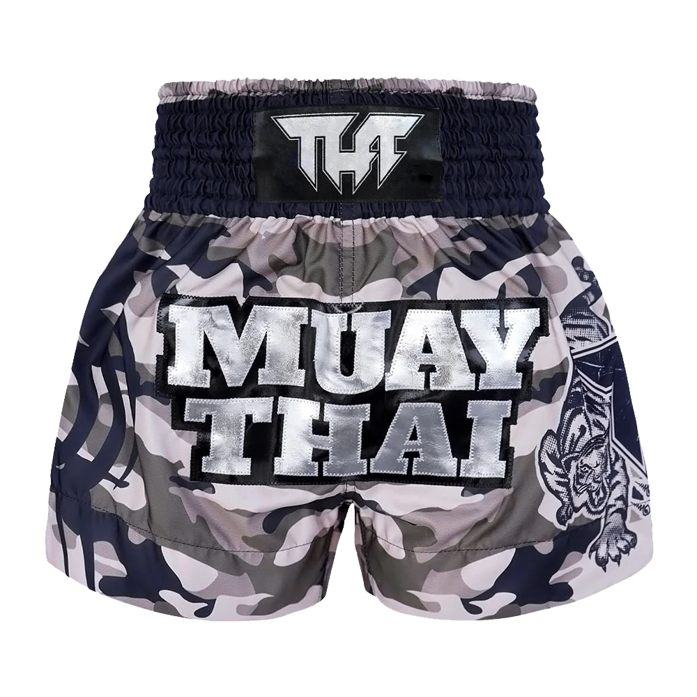 Camouflage Muay Thai shorts with 'Muay Thai' text and tiger design on a white background