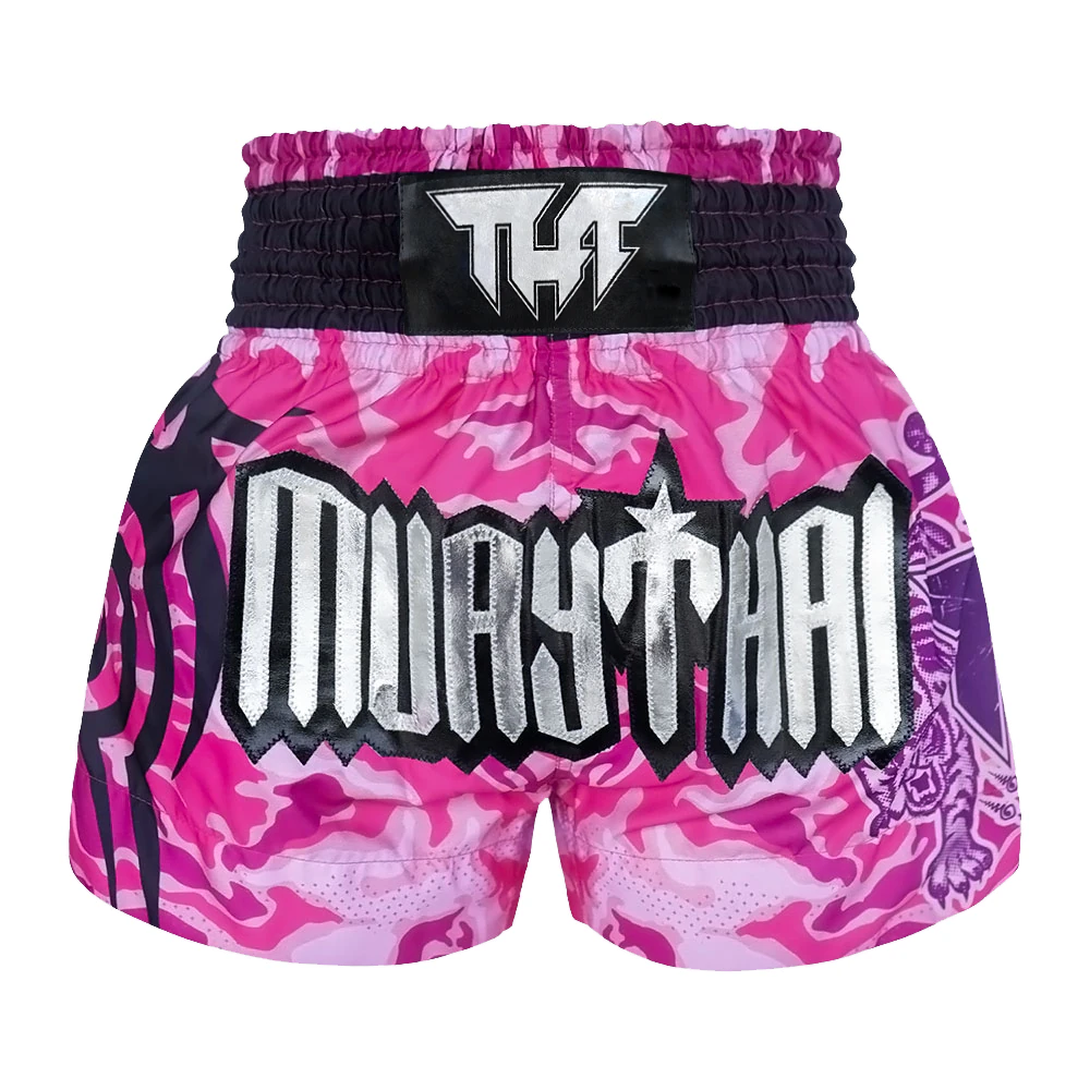 Pink and purple camouflage Muay Thai shorts with 'Muay Thai' text on a white background