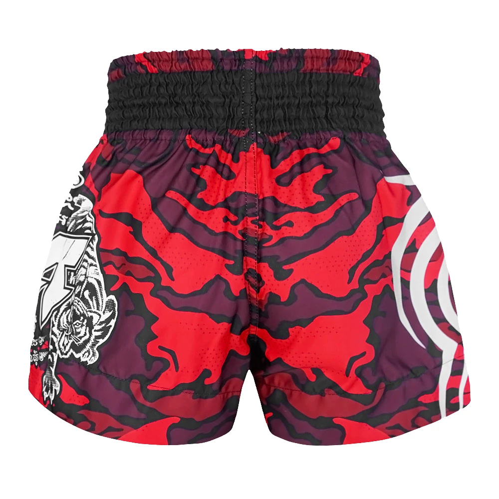 Red and black camouflage thai shorts with white designs on a white background