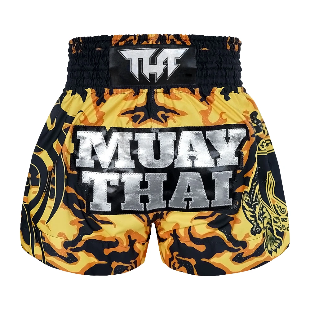 Yellow and black Muay Thai shorts with 'Tuff' logo on a white background