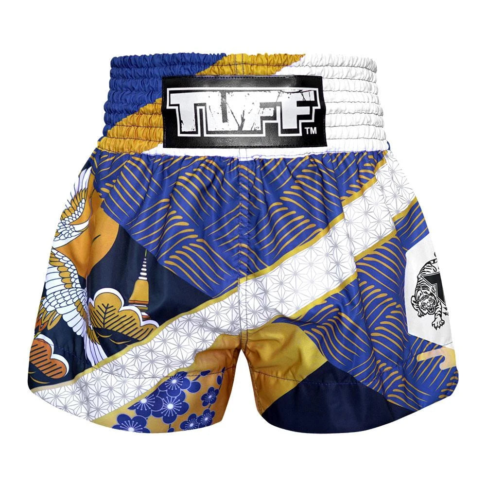 Colorful Muay Thai shorts with a brand logo on a white background