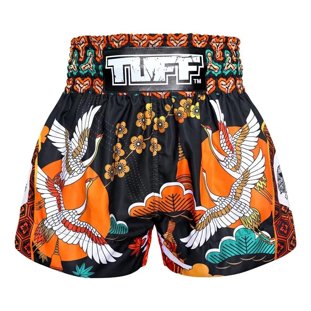 Colorful Muay Thai shorts with bird and floral patterns on a white background