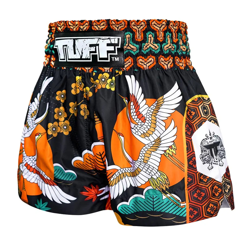 Colorful Muay Thai shorts with a prominent brand logo on a white background