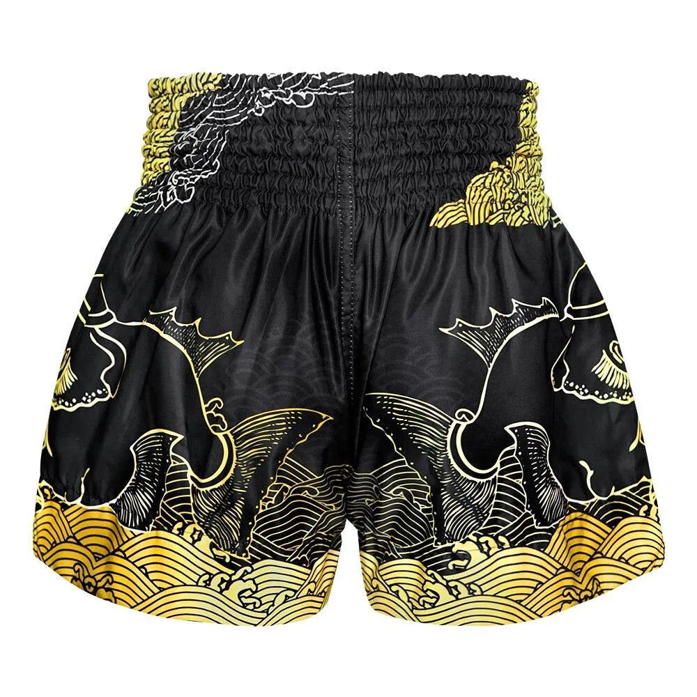 Black Muay Thai shorts with gold and white patterns on a white background