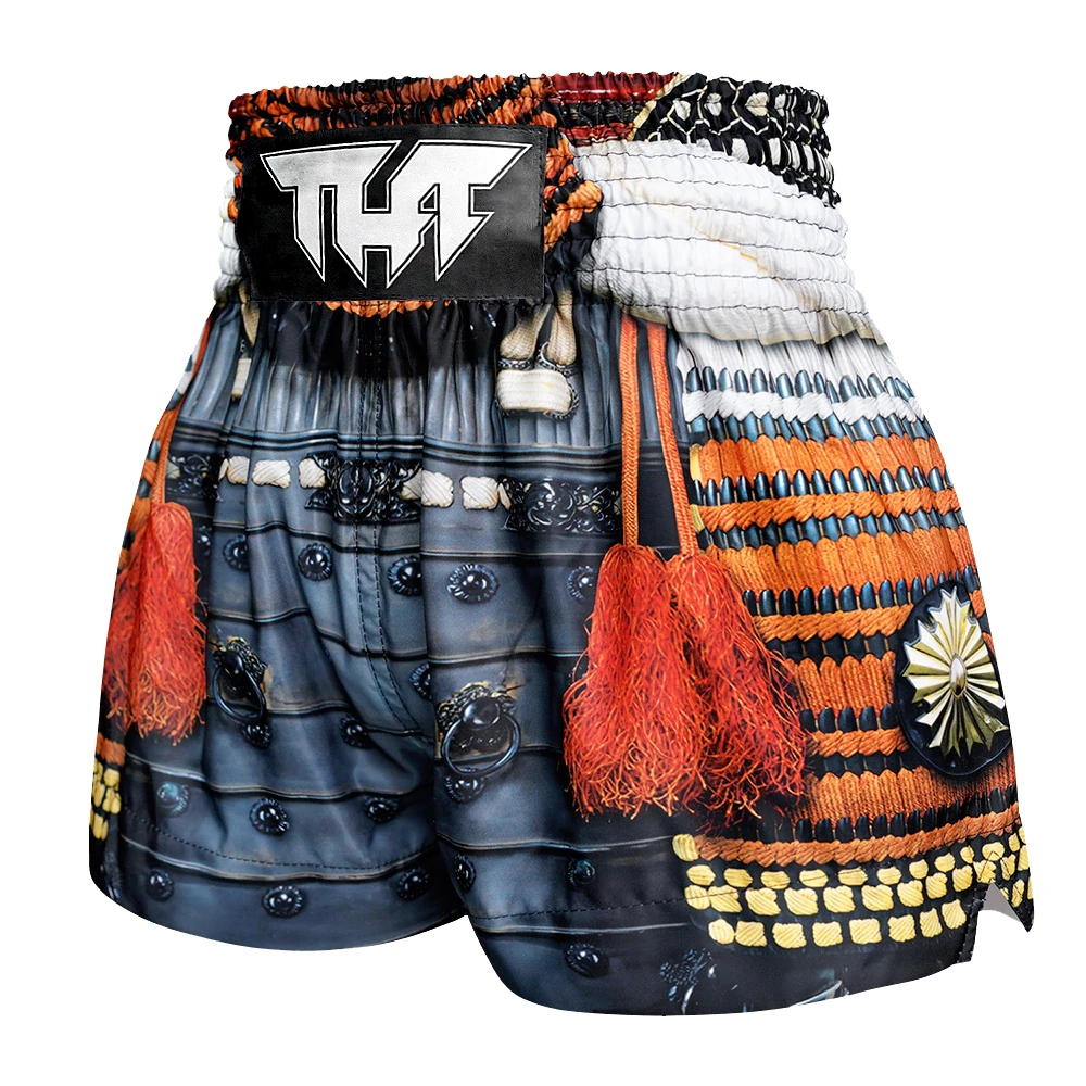 Colorful traditional-inspired Muay Thai shorts with decorative elements on a white background