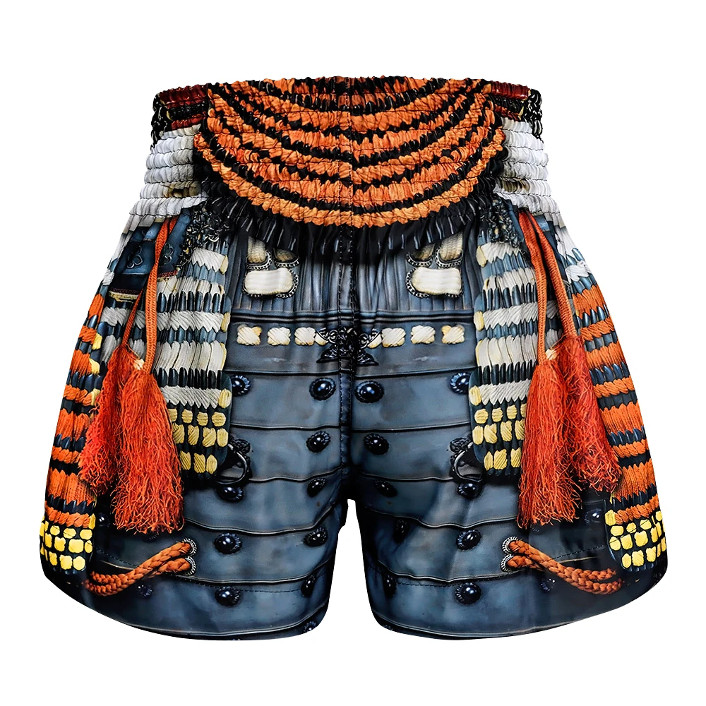 Decorative Muay Thai shorts with intricate patterns and tassels on a white background