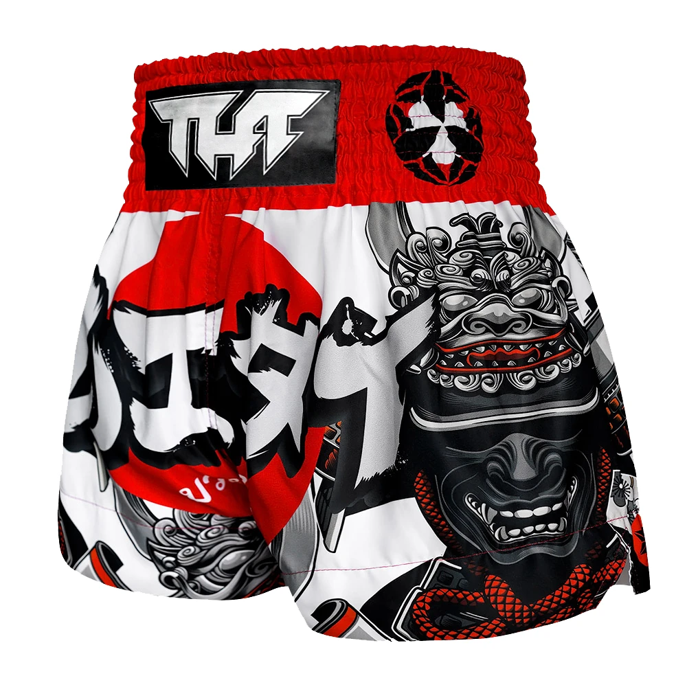 Muay Thai shorts with black, white, and red design on a white background